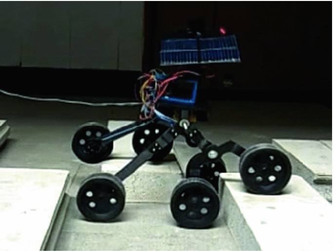 The rocker-bogie chassis moving over a rough terrain